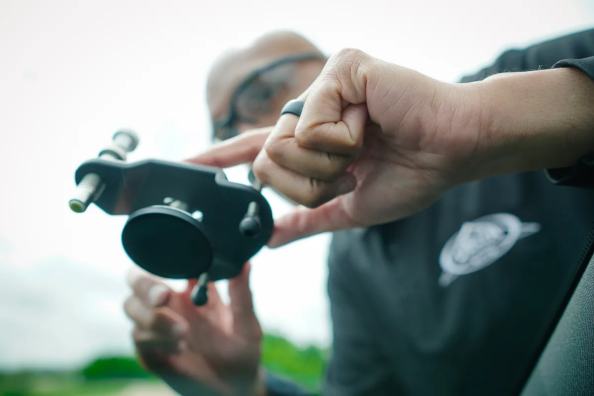 Technician working on an outdoor windshield repair with professional bridge equipment